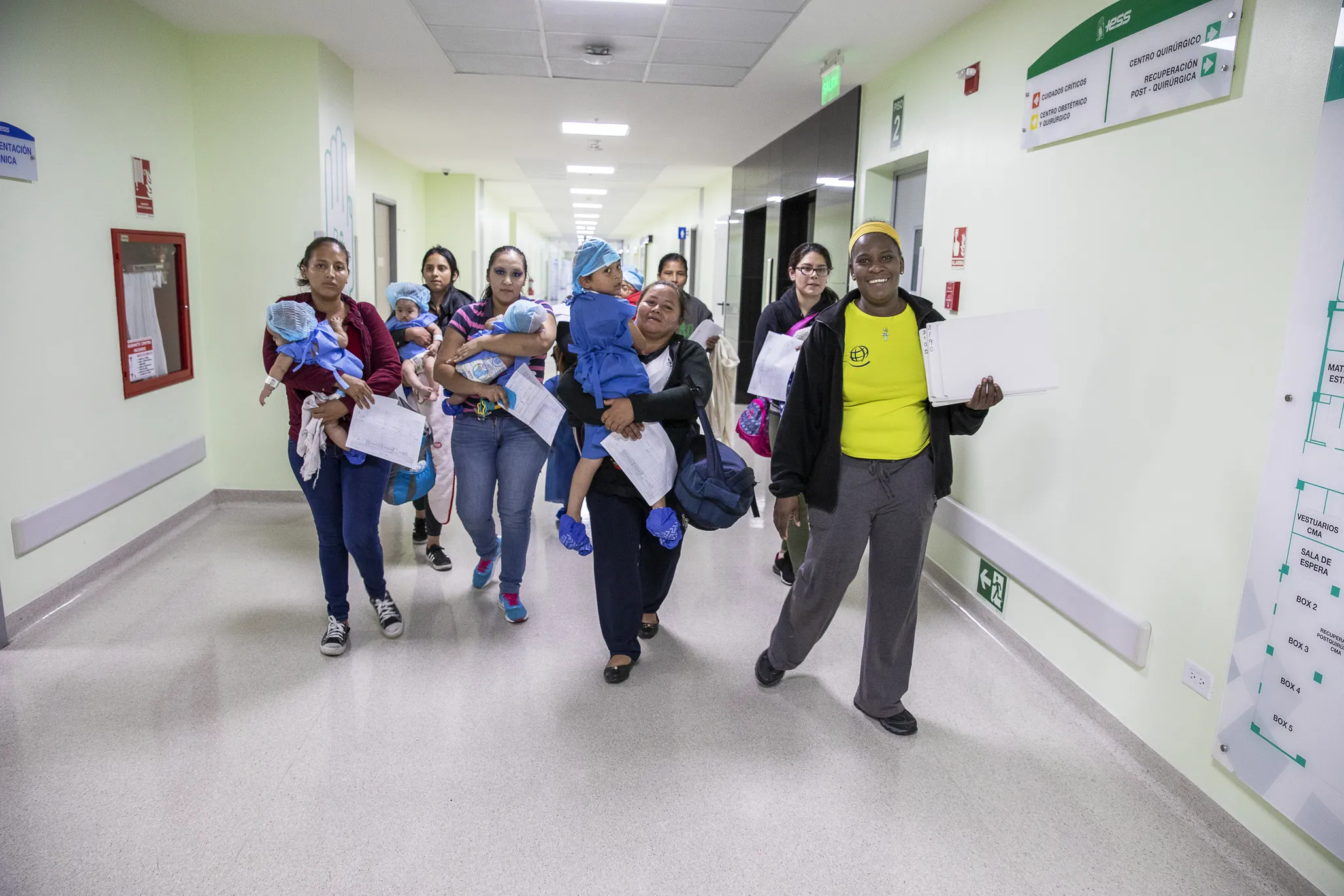 During a 2019 surgical program in Ecuador, Homaire escorts a group of patients and their mothers toward the child life area, which is the final stop before entering the operating room for surgery.