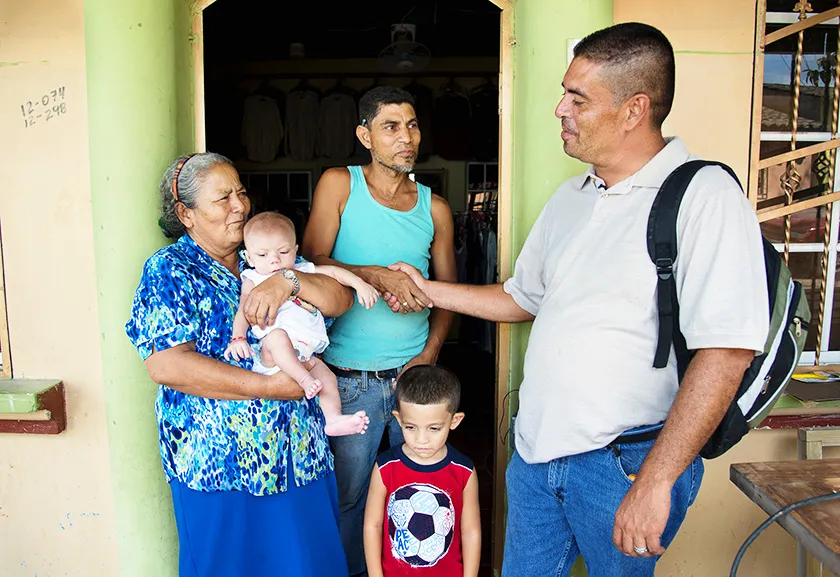 Don Alex speaks with a family.