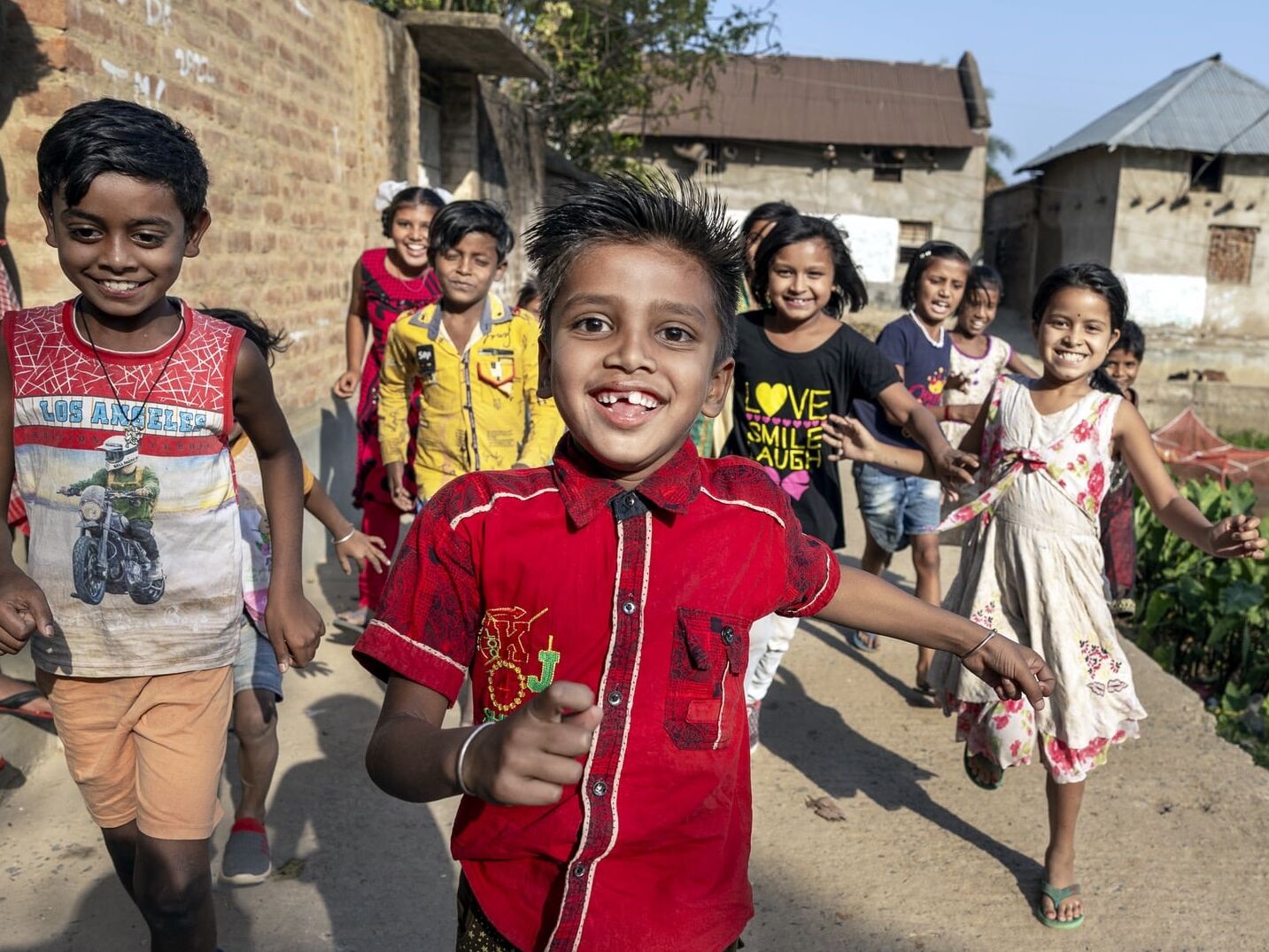 Shyam runs towards the camera with friends.