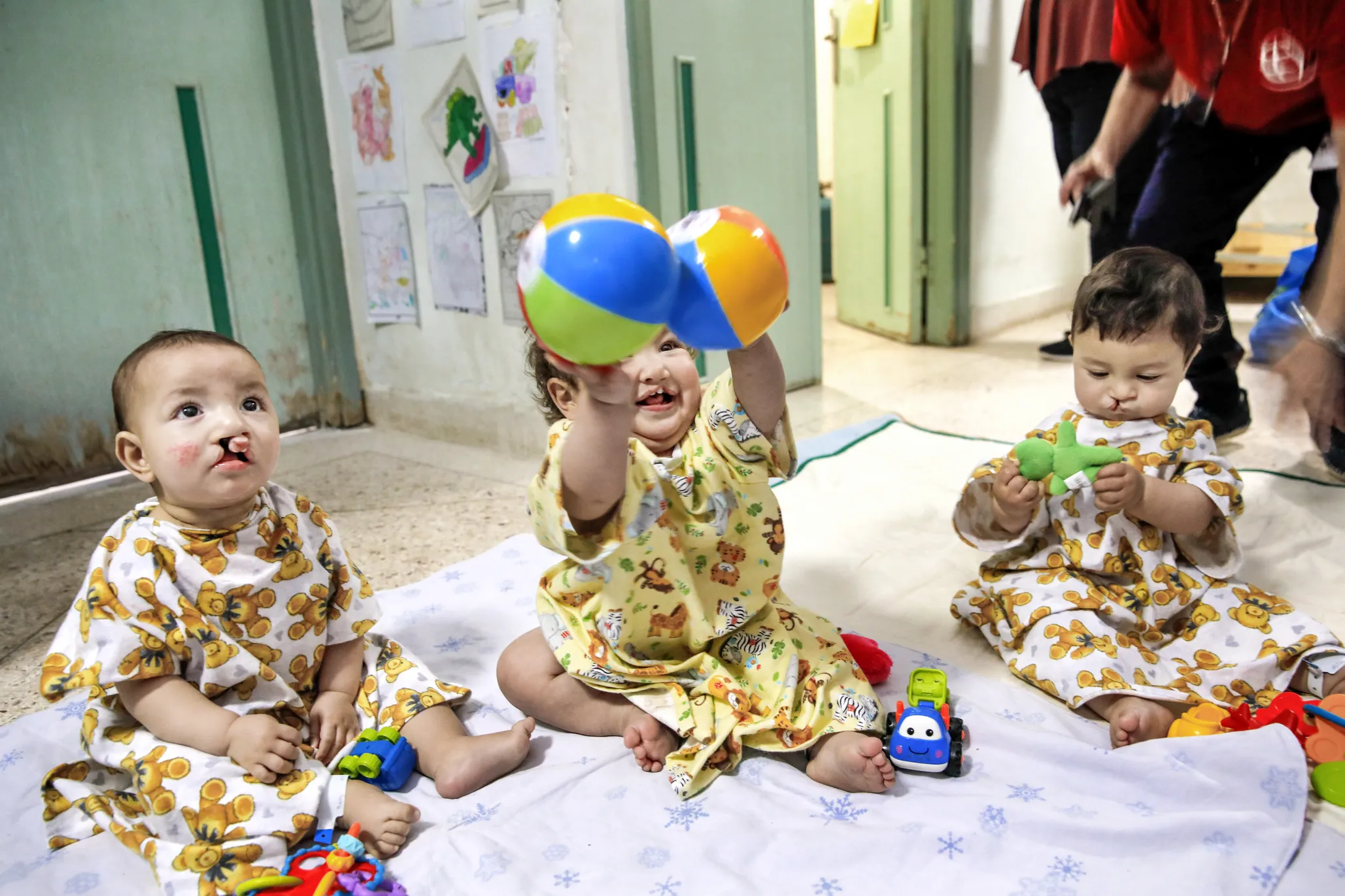 Eight-month-old Elmehdi, right, 11-month-old Ouissal, center, and another young patient await their life-changing surgeries.