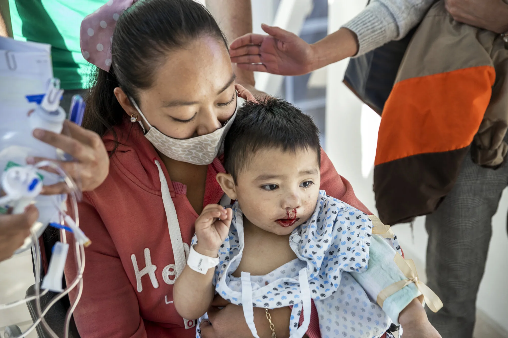 María holds Sebastian in her arms moments after the surgical team returns from the operating room following his successful cleft lip surgery.
