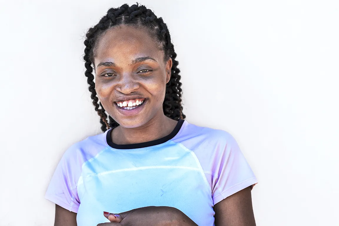 Operation Smile Malawi volunteer Carol Chigona smiles for the camera.