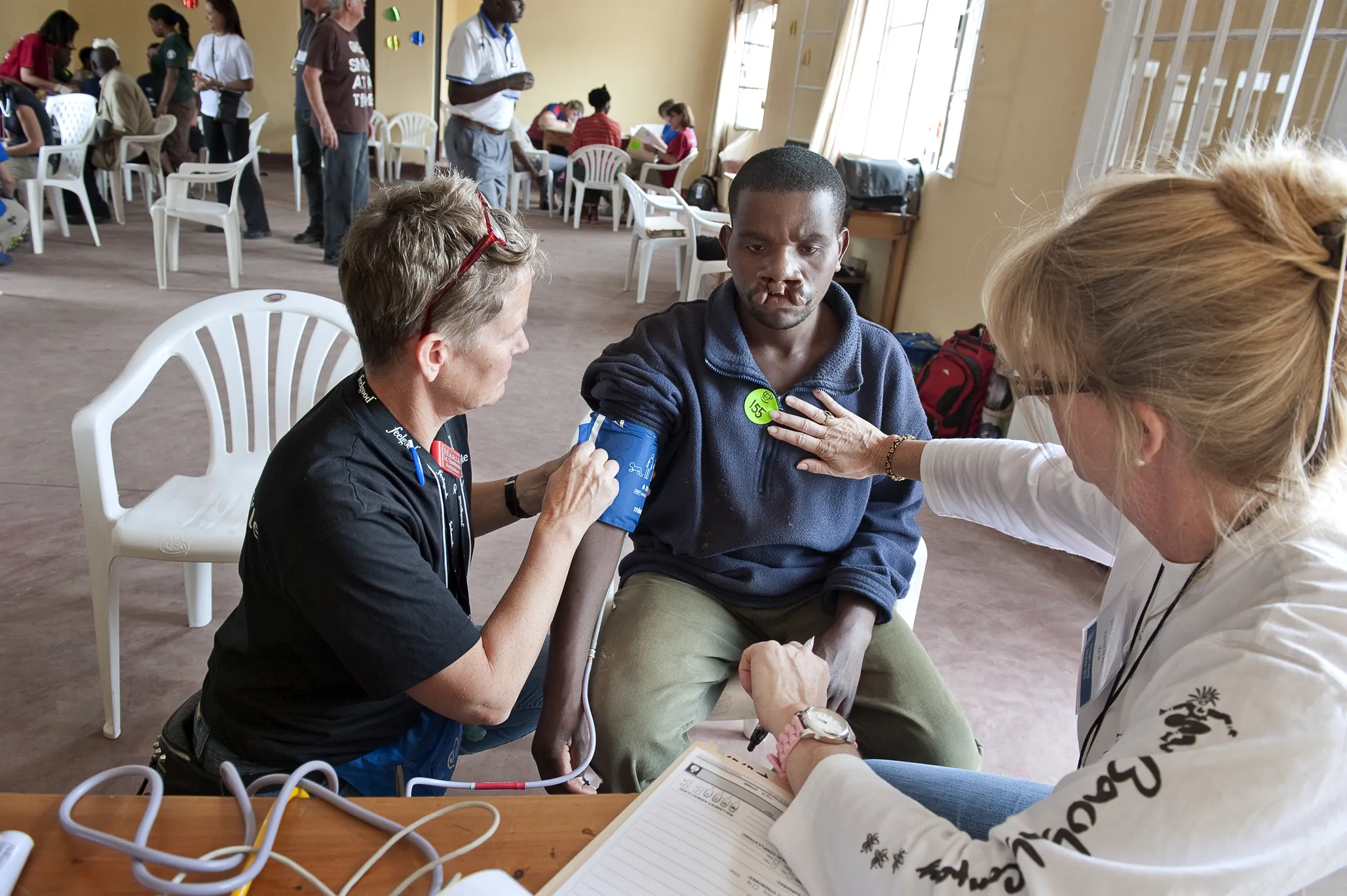 Volunteer pre- and post-operative nurse Maria Dahlin of Sweden screens Enok during a 2013 surgical program in Rwanda.