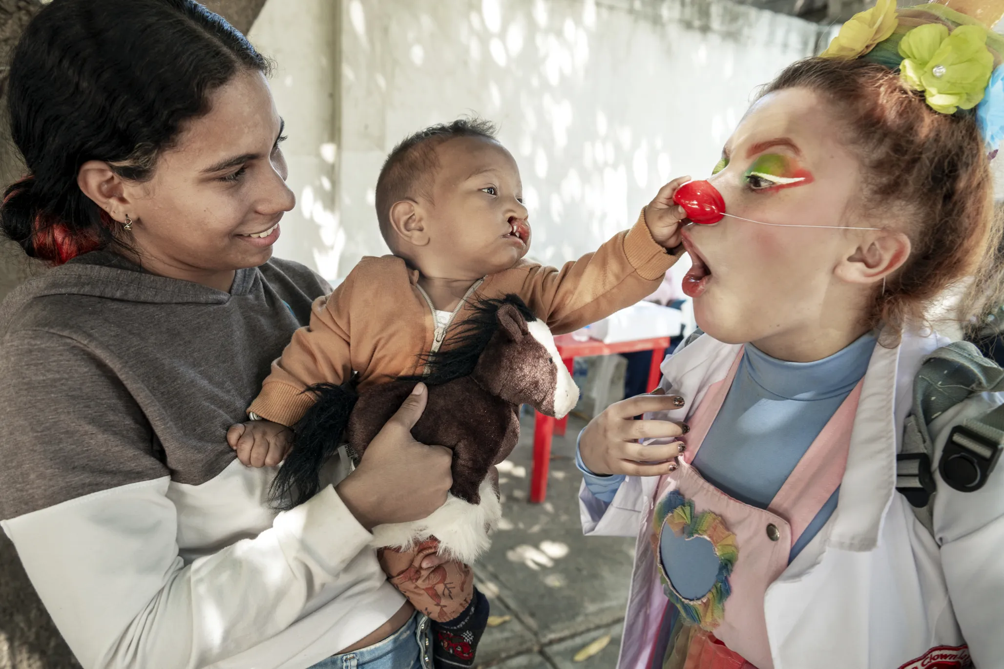 Ihan squeezes the nose of a member of Clowns without Borders.