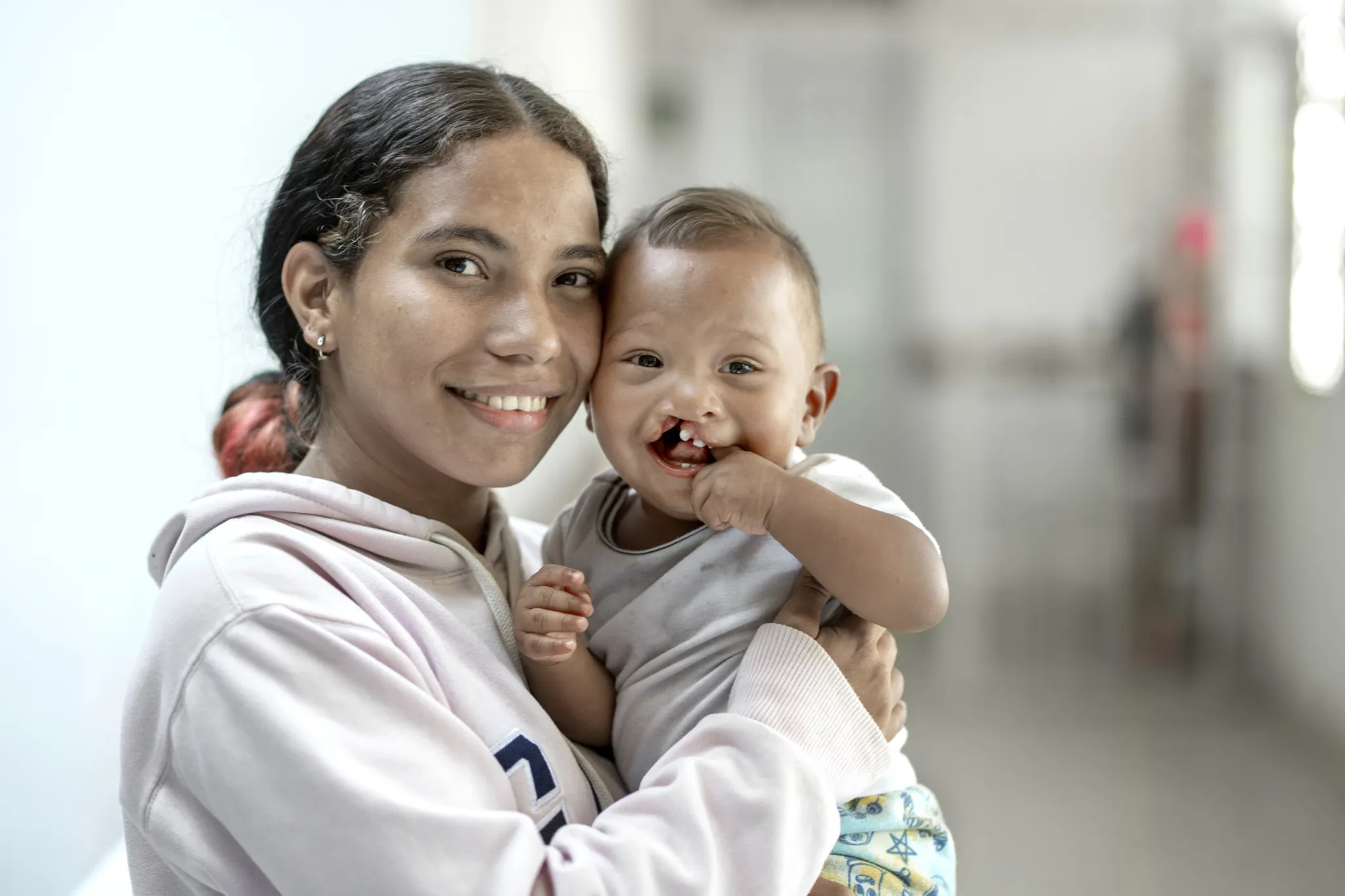 Ihan smiles for the camera with his mother, Carla.
