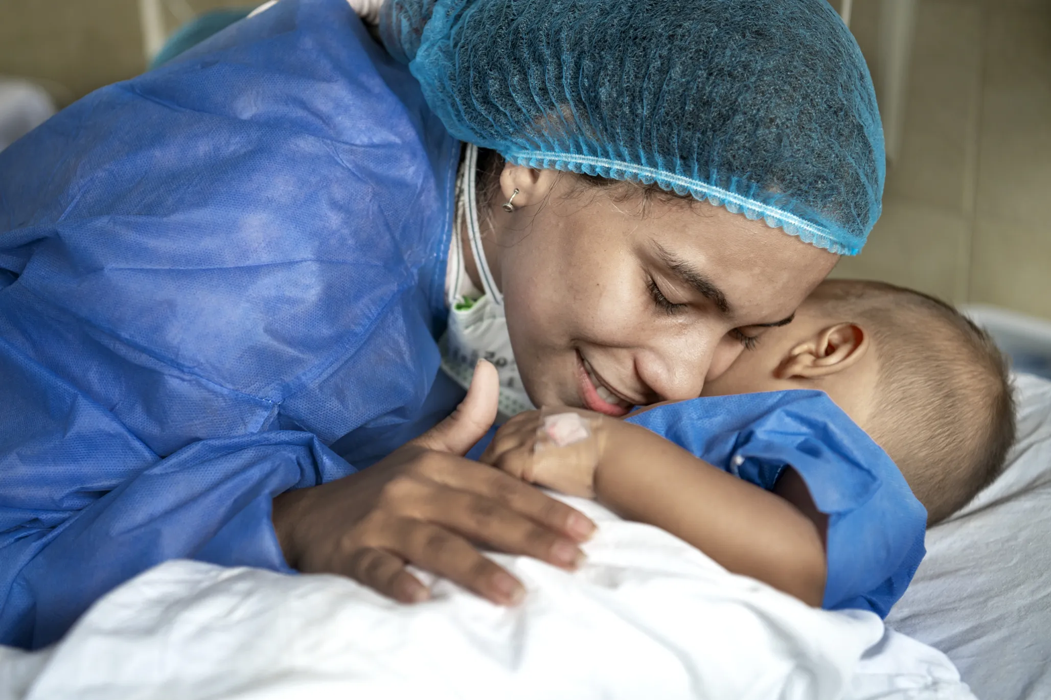 Carla snuggles with Ihan after surgery.