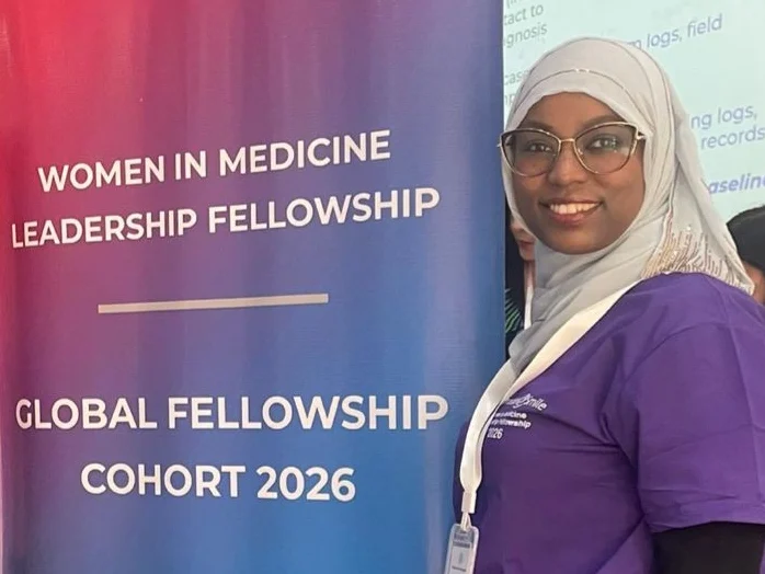 Dr. Fetiya Awol poses with a banner.