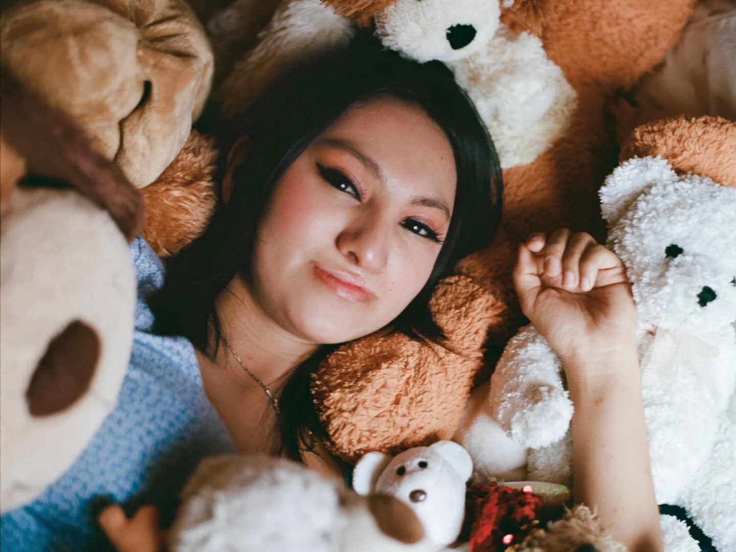 Palisha, surrounded by stuffed animals she received from Operation Smile.