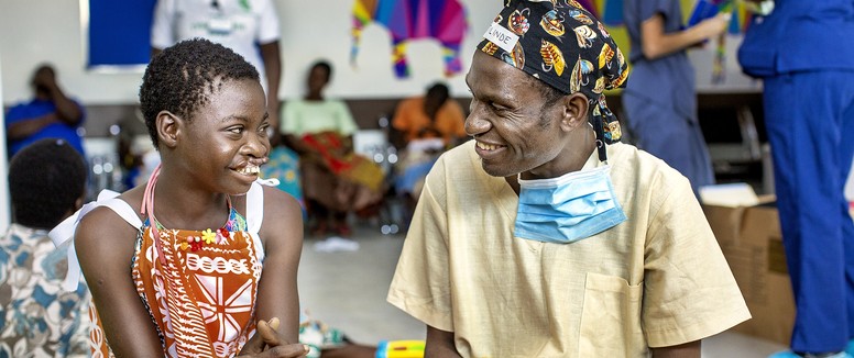 Volunteer surgeon Dr. Tilinde Chokotho speaks with 12-year-old Belita before her surgery during Operation Smile's 2019 mission to Lilongwe, Malawi.