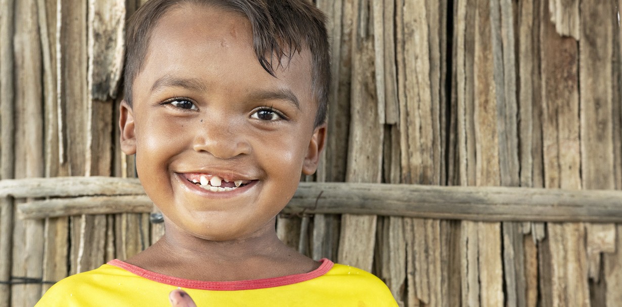 One year after his cleft lip surgery, Pedro smiles proudly in front of his house in Uribia, Colombia. Photo: Camilo Zapata Fonnegra.