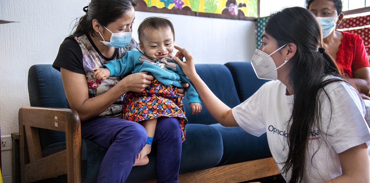Nutritionist Monica Arredondo evaluates 10-month-old Jobito as he sits on his mother's lap prior to surgery. Jobito was one of Operation Smile Guatemala's nutrition program graduates. Nutrition is a key component of Operation Smile's comprehensive cleft care.Photo: Rohanna Mertens.
