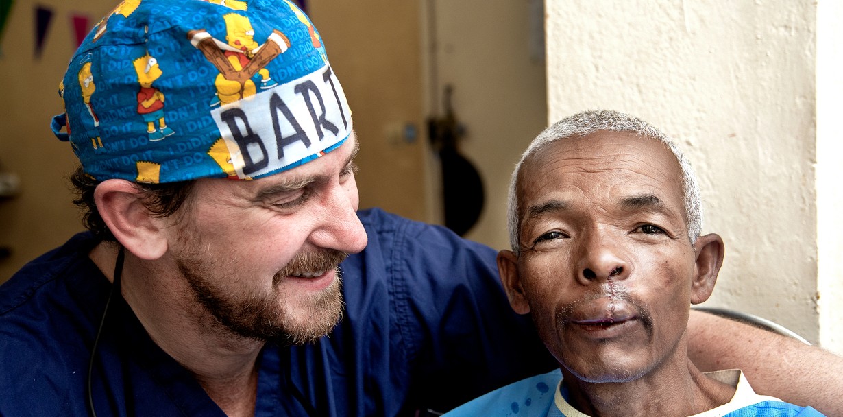 After surgery, 52-year-old Alfred poses with his surgeon Dr. Bart Stubenitsky of the Netherlands in the recovery room.