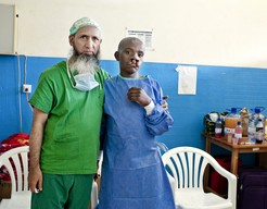 Operation Smile volunteer cleft surgeon Dr. Ghulam Qadir Fayyaz of Pakistan poses for a pre-surgery photo with Enok of Rwanda during 2013 surgical program.