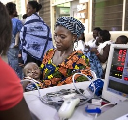 A young patient's vital signs are checked as his mother comforts him at Operation Smile Ghana's first local mission