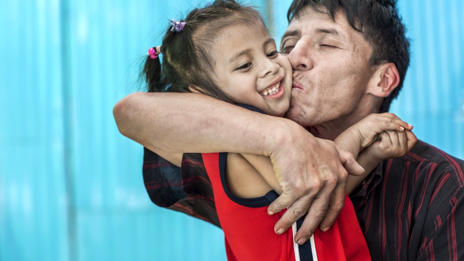 Karla, 3 years old, gets a big kiss from her dad, Angel, 15 months after she received cleft surgery from Operation Smile Mexico.