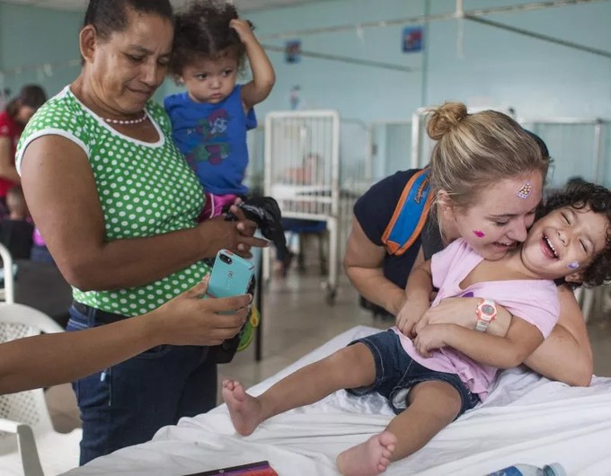 A girl plays with a volunteer nurse before undergoing surgery in Managua on April 26, 2016. Some 200 Nicaraguan children born with a cleft lip or palate a congenital defect that prevents them talking, eating and breathing properly are being operated by doctors with the charity Operation Smile, with the support of the Nicaraguan government.