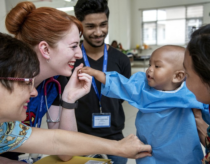 From left, post-op nurses Karen Allen of Australia and Lora Edwards of the U.K. and translator Animesh Mukherjee with Ezhan, 10 months, female, and her mother during Operation Smile India's medical mission at IQ Medical College Hospital in Durgapur, India, on February 26, 2020.