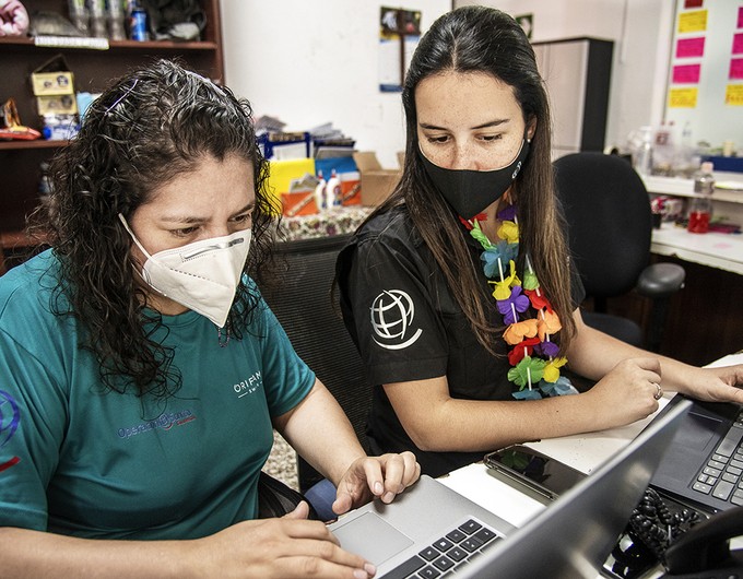 National registry coordinator Paola Arroyave wears a black Operation Smile shirt while she sits beside care center coordinator Rosa Solares, who is wearing a teal Operation Smile Guatemala during a surgical program in Guatemala City.