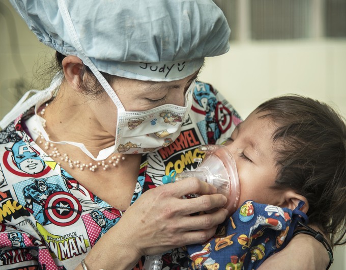 Anesthesiologist Judy Nguyen holds 2-year-old Juan Carlos on the first day of surgery during the Operation Smile mission at San Felipe Hospital in Tegucigalpa, Honduras, on February 20, 2017.