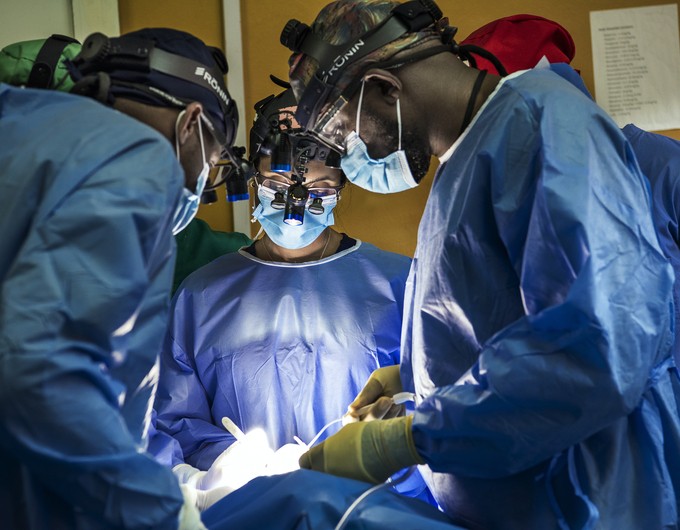 Dr. Priyanka Naidu, Operation Smile medical advisor, center, performs surgery as Rwandan colleagues assist and observe during a surgical program in Bushenge, Rwanda. 