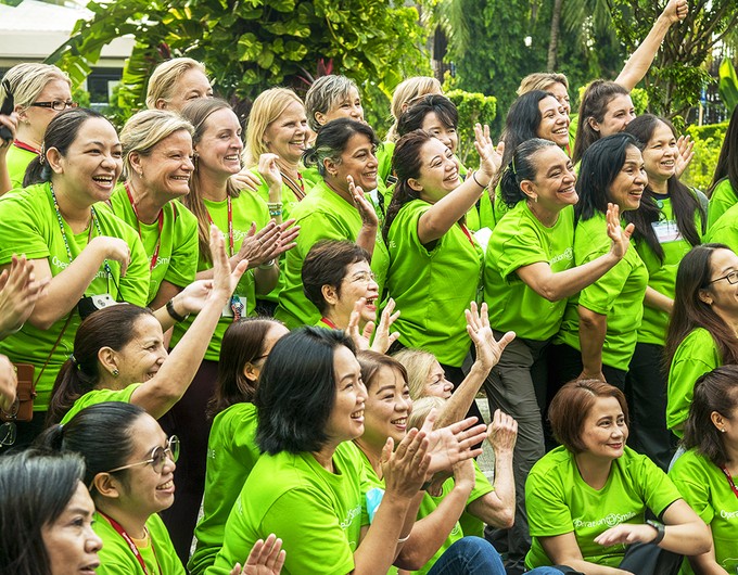 Wearing the signature lime green T-shirt, Women in Medicine volunteer team takes a team photo in Cebu City, Philippines, before the start of the Oct. 2022 all-women's program.