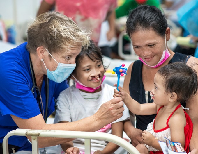 During the Women in Medicine surgical program in the Philippines, Kisha plays with an Operation Smile volunteer before her surgery.