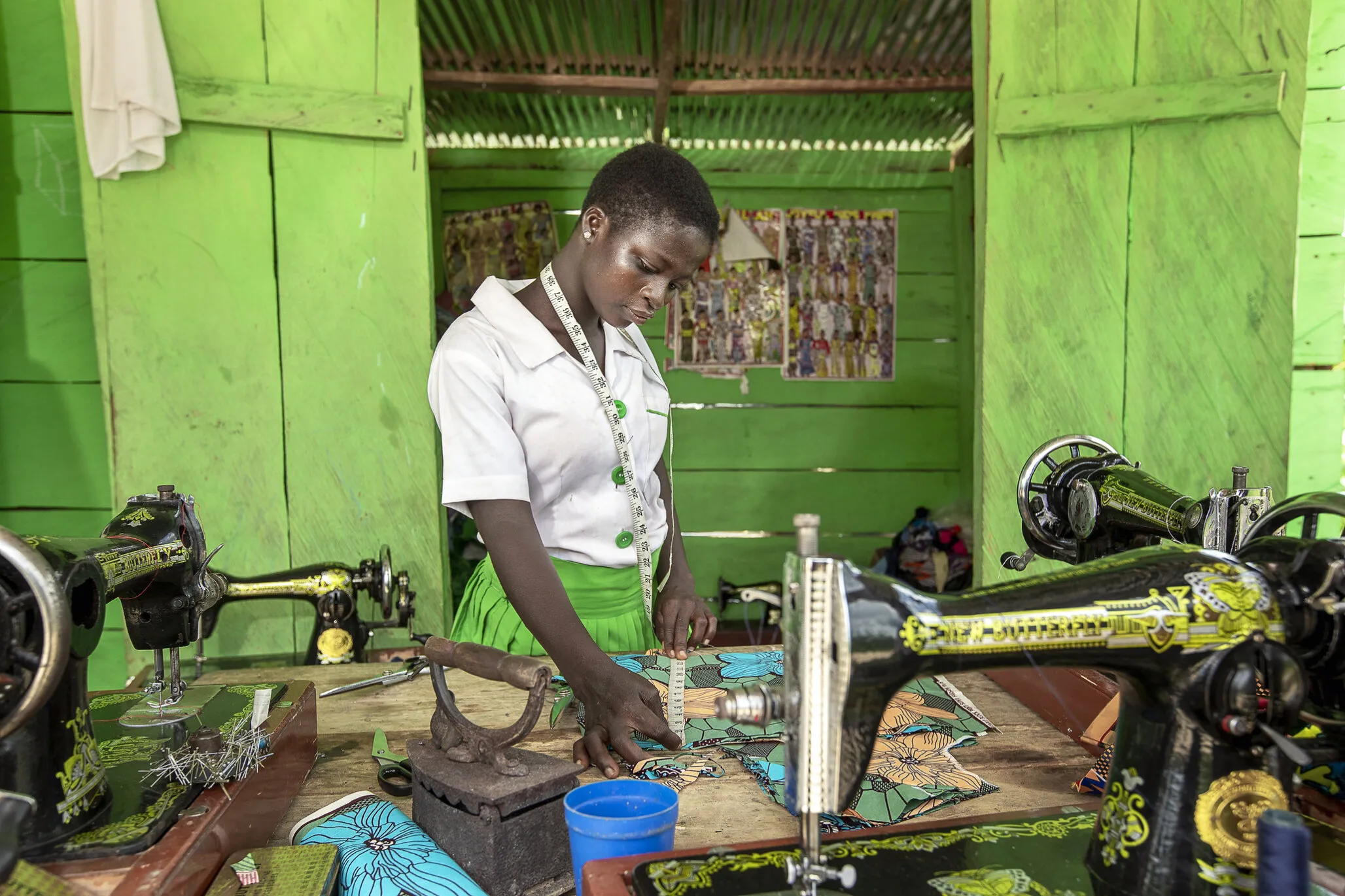 Faustina measures fabric.