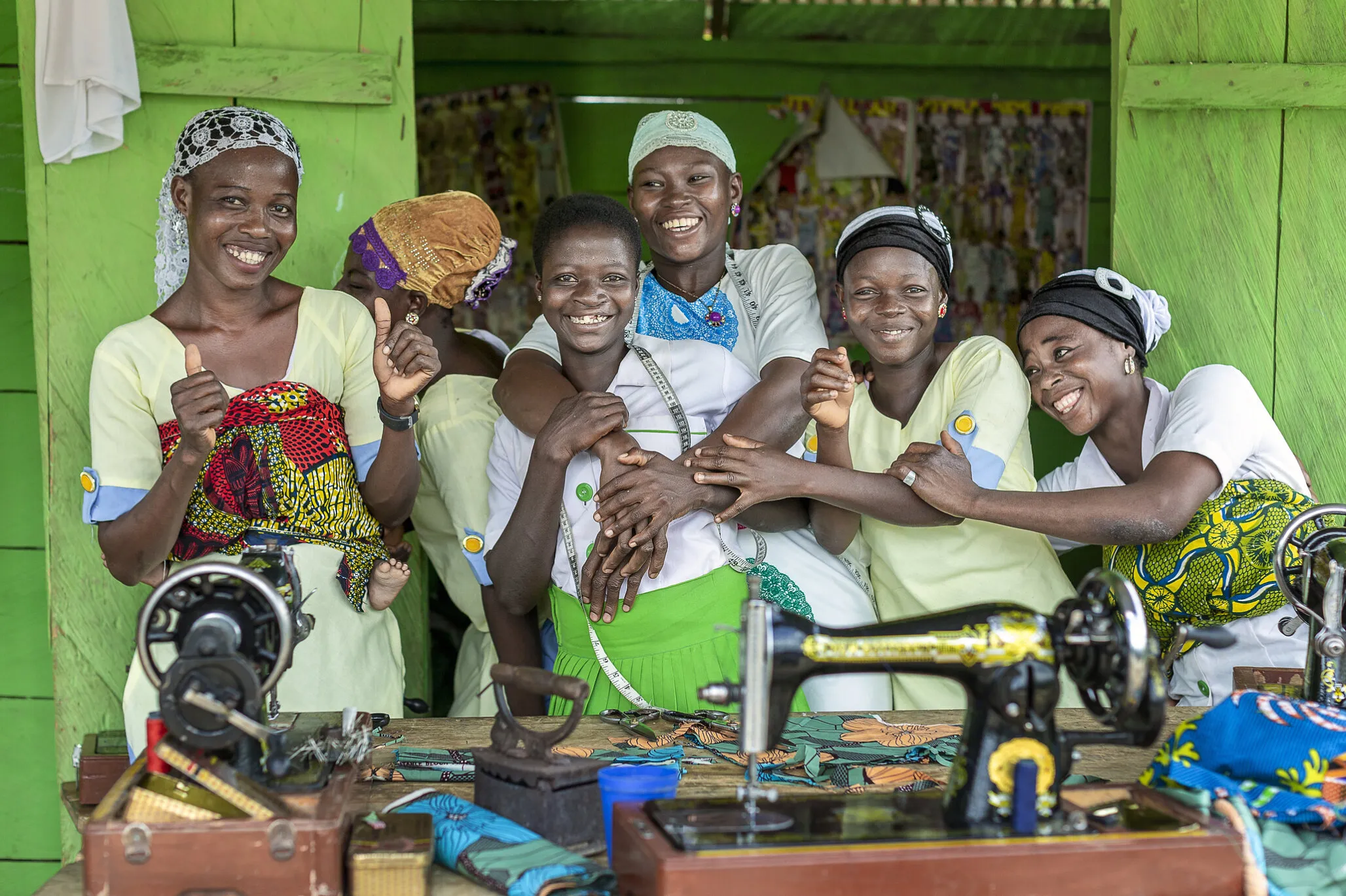 Faustina, her teacher, Memunatu, center, and her fellow sewing apprentices.