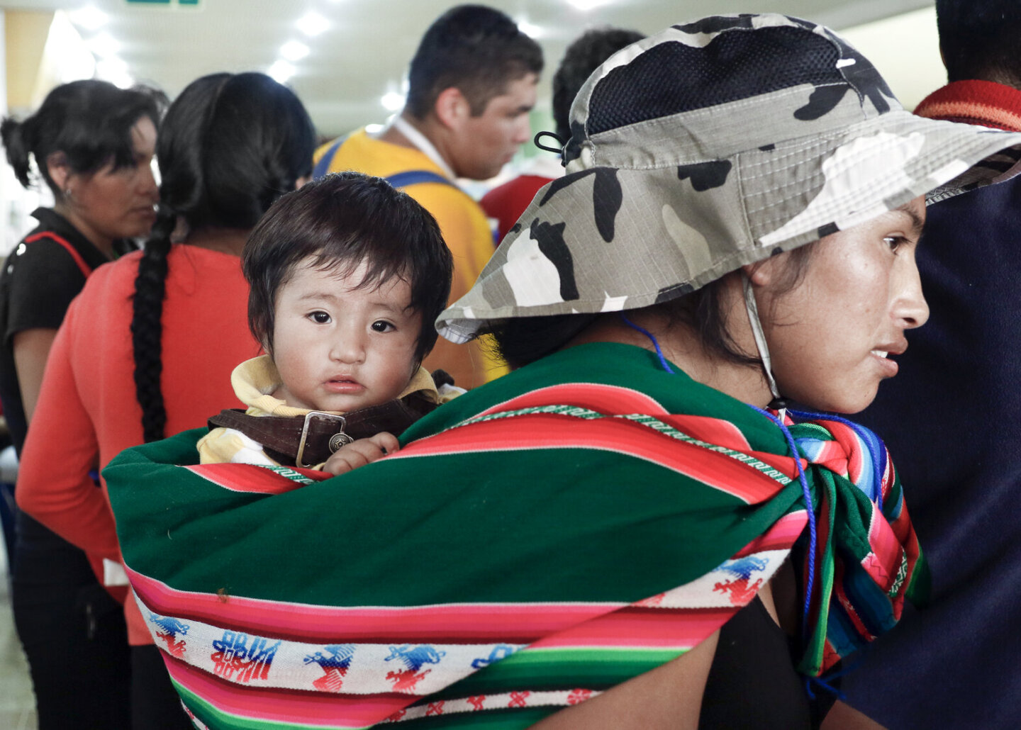 Andy, held by his mother, attends a program in Santa Cruz, Bolivia.