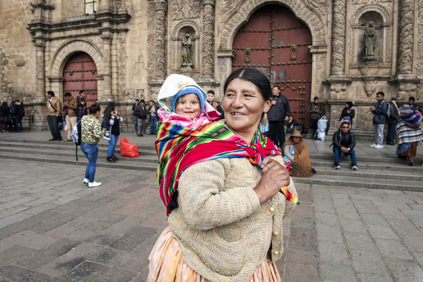 Heydi, held by her grandmother.