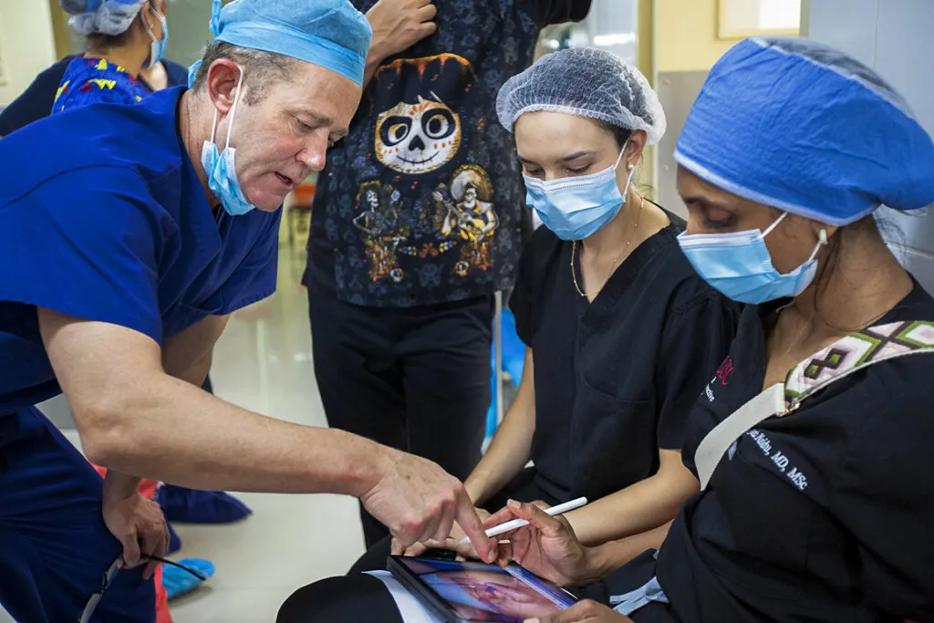 Dr. Billy Magee discusses surgical techniques while in Santa Cruz, Bolivia.