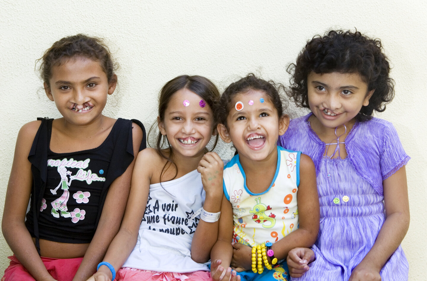 Antonia, pictured second, poses for a photo surrounded by fellow patients and friends during an Operation Smile Brazil surgical program to Fortaleza.