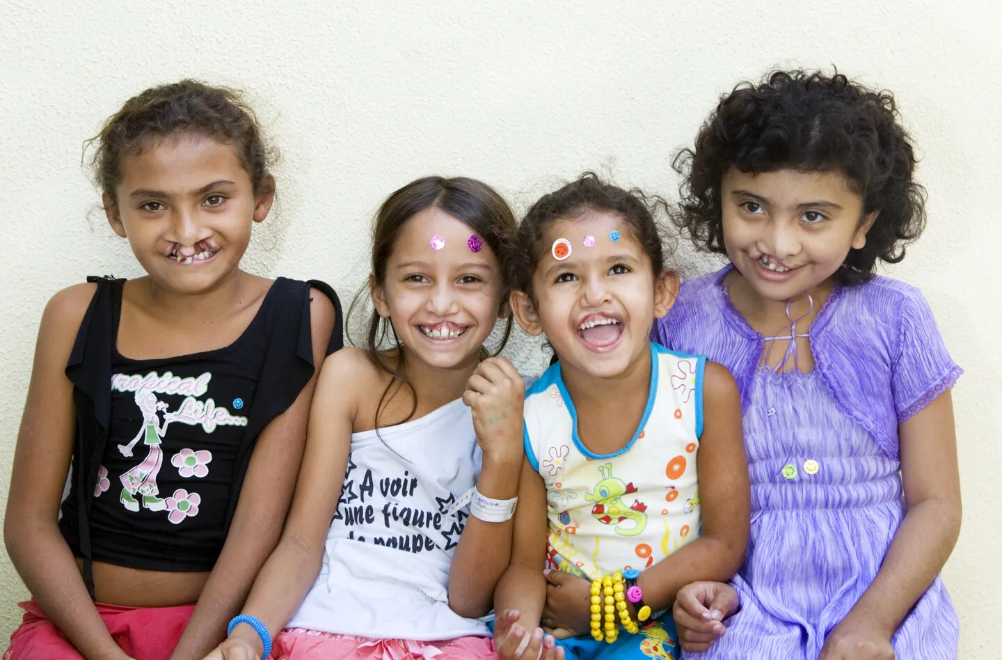Antonia, pictured second, poses for a photo surrounded by fellow patients and friends during an Operation Smile Brazil surgical program to Fortaleza.