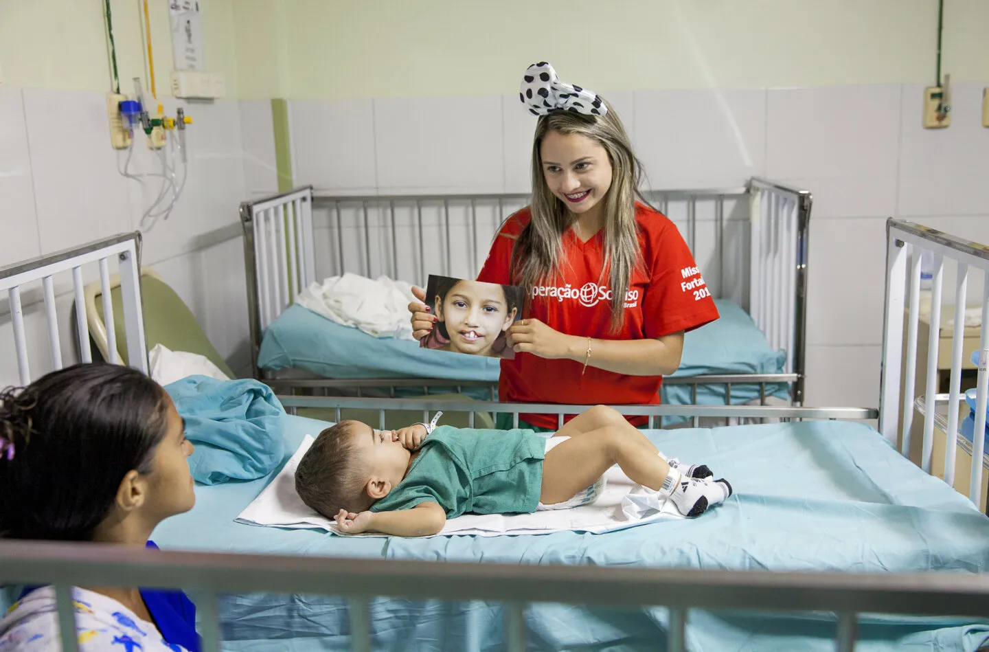 Antonia shares her personal cleft care story with 15-month-old Joao Lucas and his mom prior to him entering the operating room for his surgery.