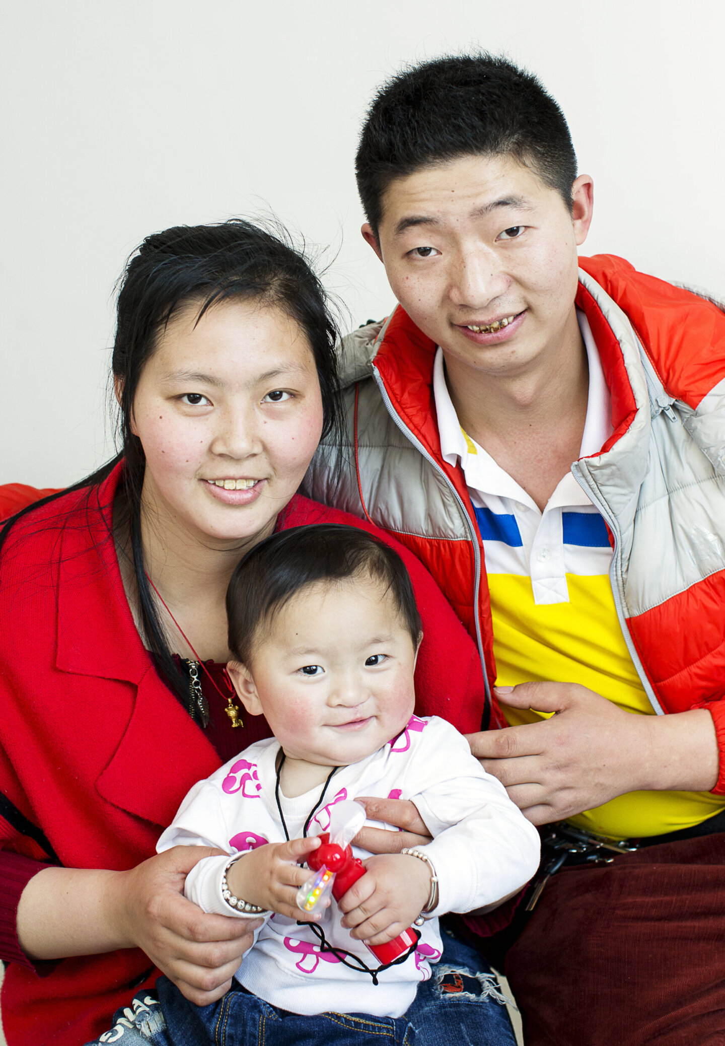One-year-old Yi Miang poses for a photo with his parents, Lu Gong'e and Tian Shun, during Operation Smile China's 2017 surgical program in Dafang.