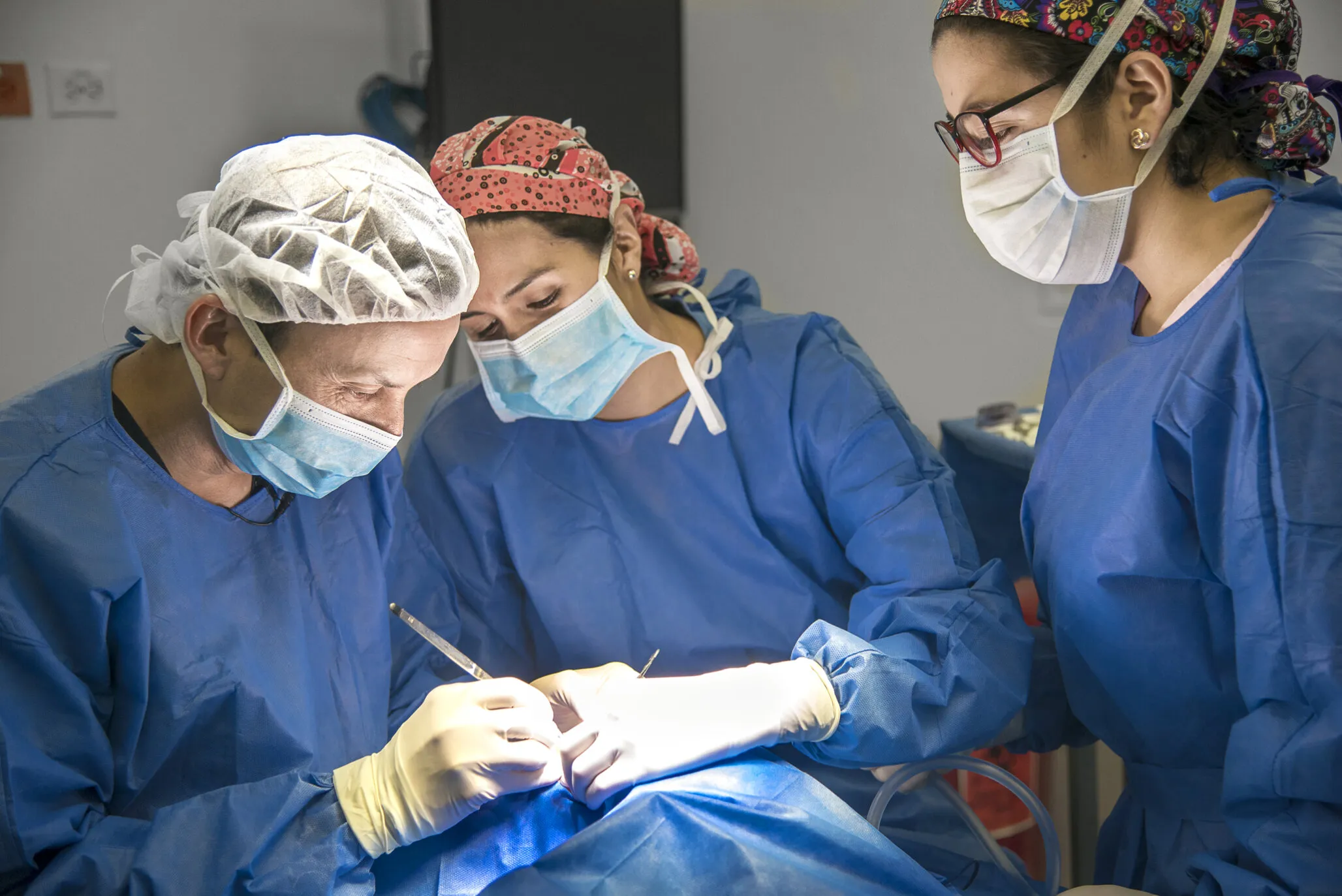 Operation Smile Colombia medical director and cleft surgeon Dr. Mauricio Herrera, left, performs Luciana's cleft lip surgery with support from plastic surgery resident Dr. Angela Rivera and instrumentation student Valeria Garcia.
