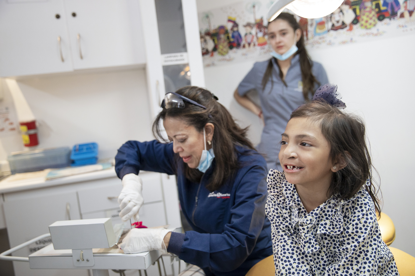 Volunteer dentist and orthodontist Dr. Nancy Rojas prepares to treat 7-year-old patient Juana at Operation Smile's care center in Bogotá, Colombia.