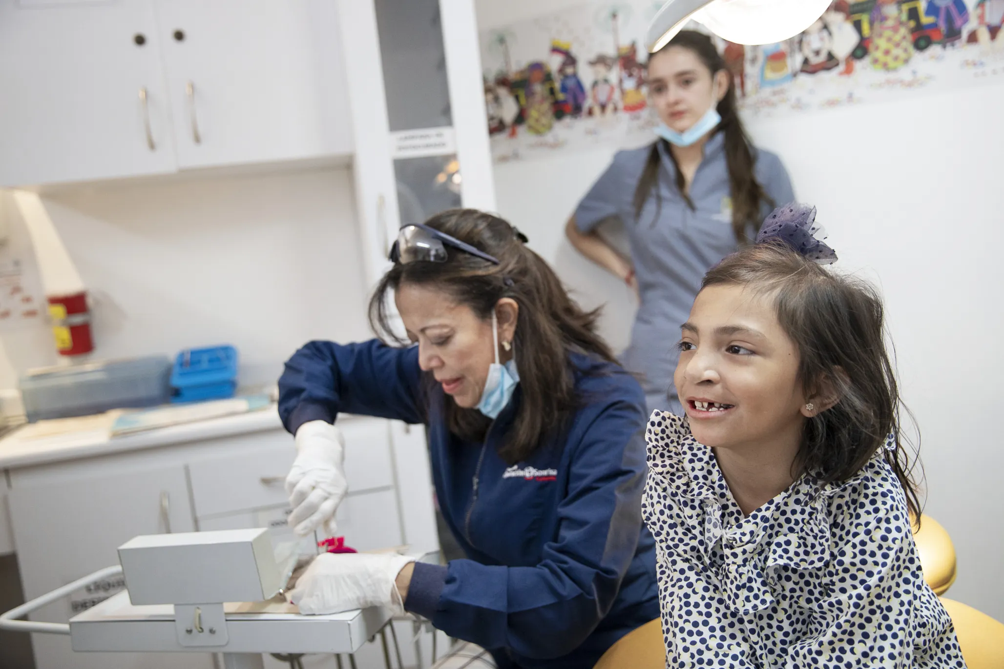 Volunteer dentist and orthodontist Dr. Nancy Rojas prepares to treat 7-year-old patient Juana at Operation Smile's care center in Bogotá, Colombia.