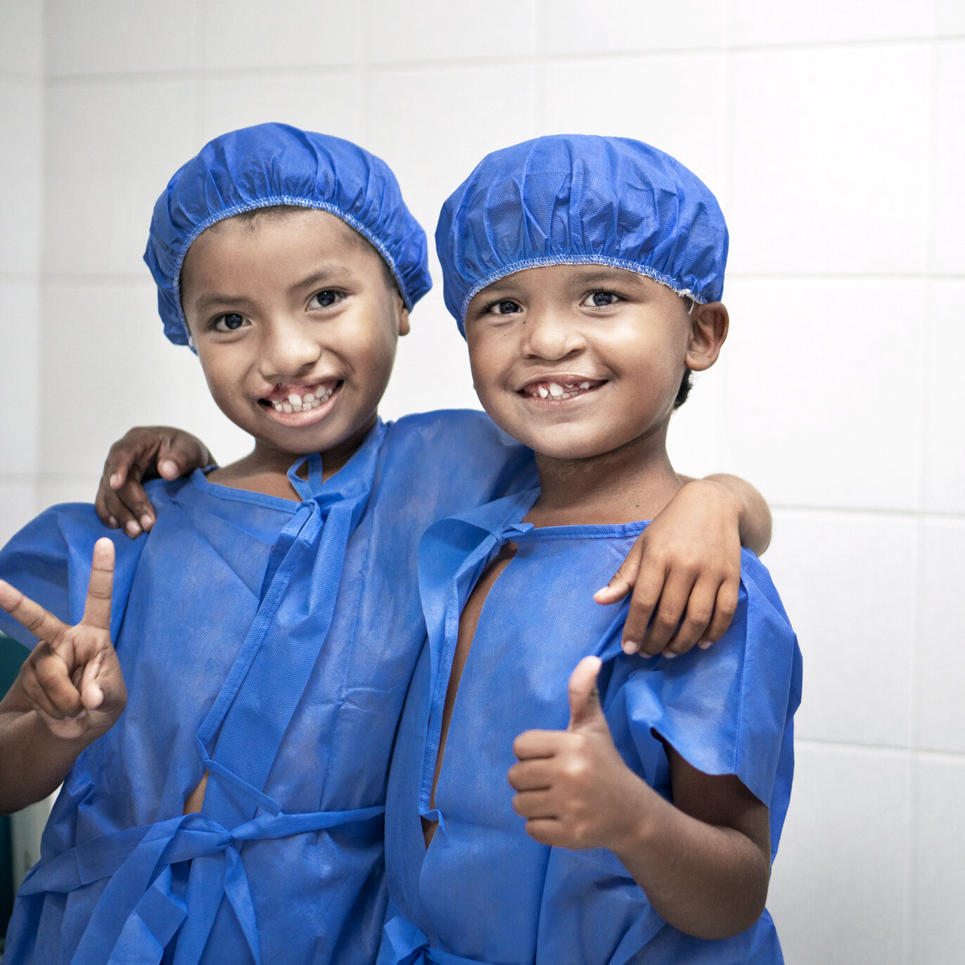 Pedro, right, meets a friend before surgery.