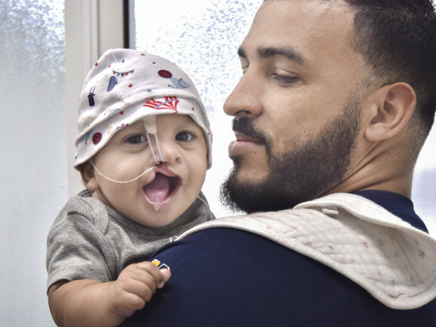 Isaac, being held by his father.