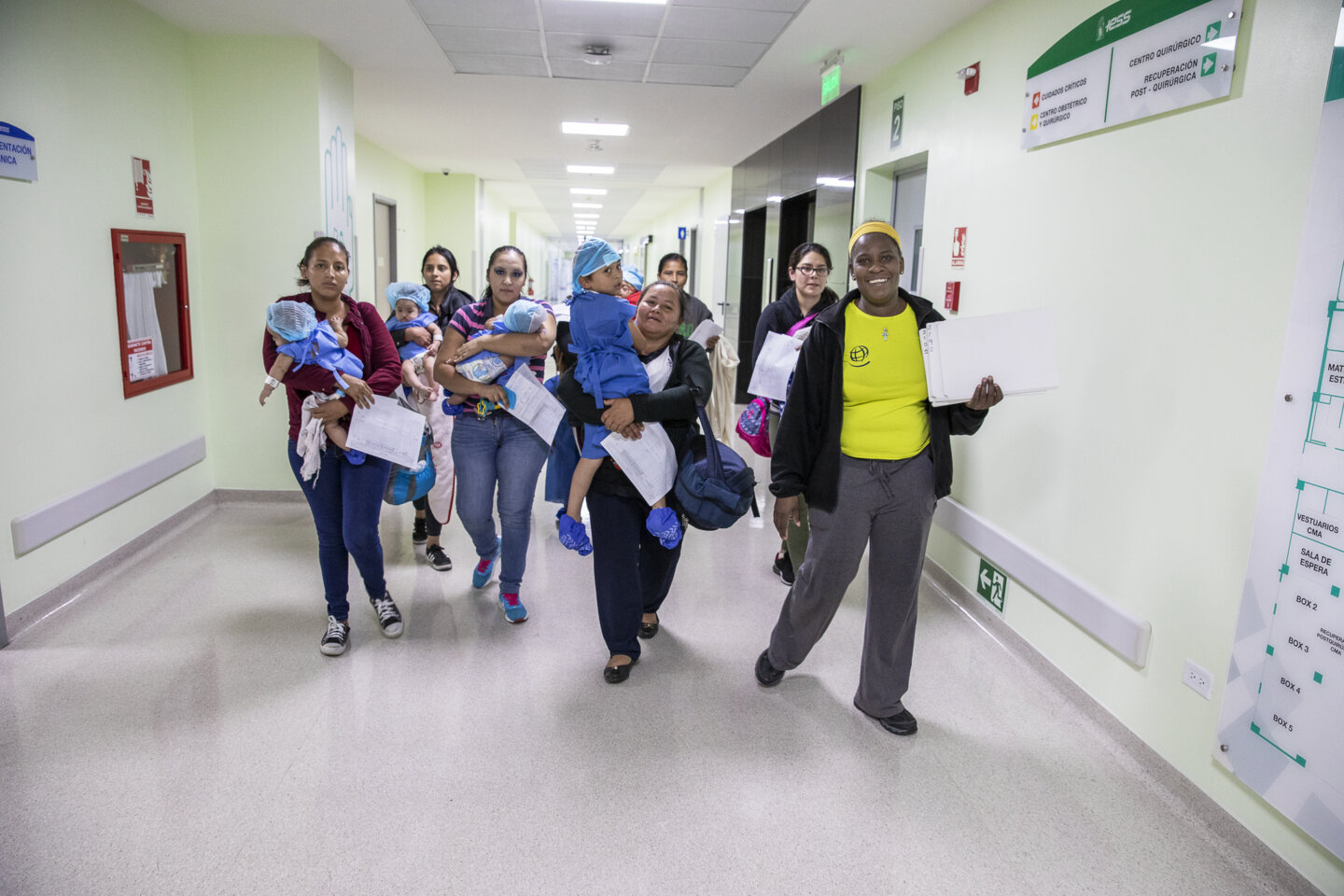 During a 2019 surgical program in Ecuador, Homaire escorts a group of patients and their mothers toward the child life area, which is the final stop before entering the operating room for surgery.