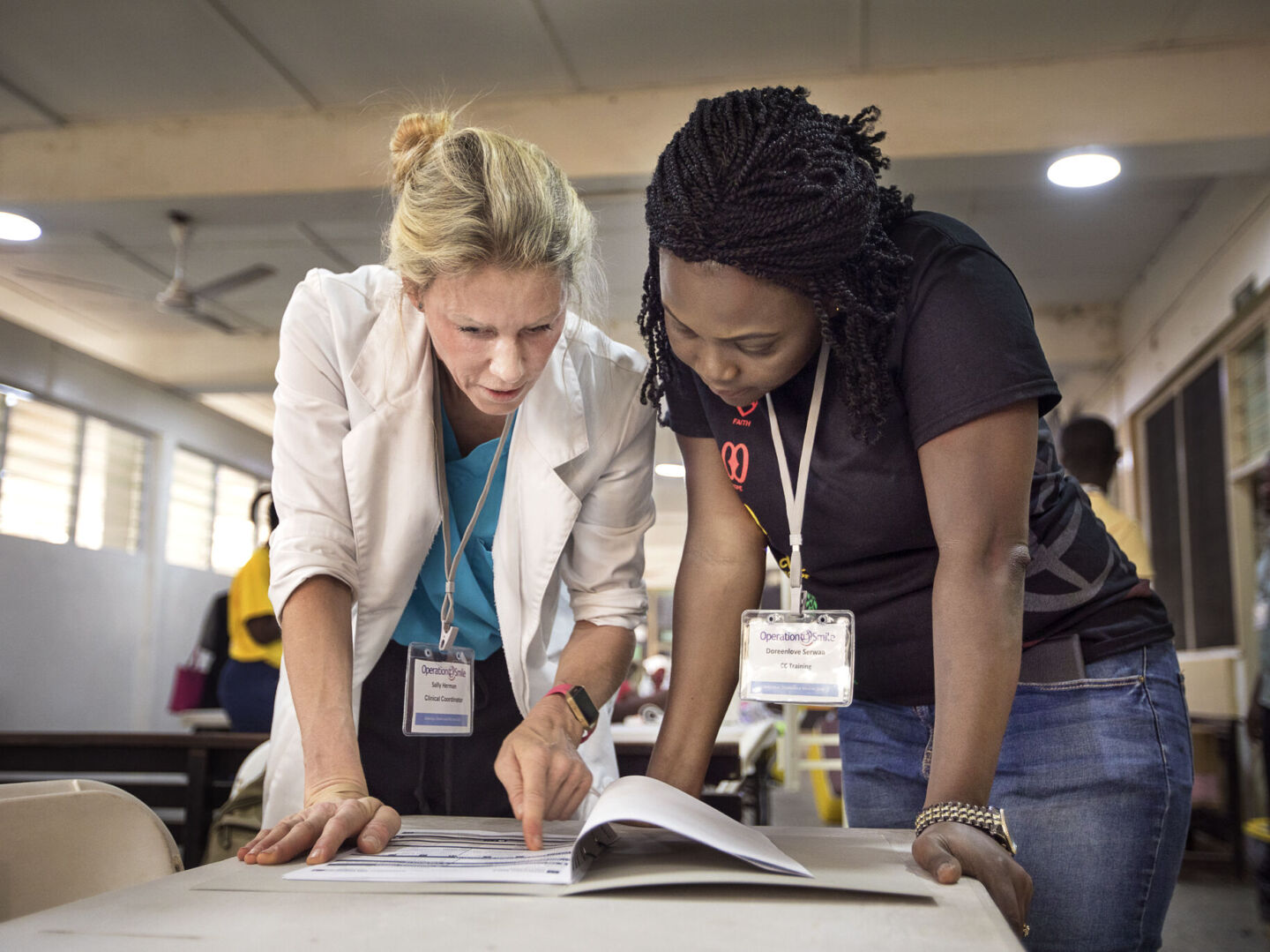 Clinical Coordinator Sally Herman with Clinical Coordinator-in-Training Doreenlove Serwaa during screening on the first day of Operation Smile Ghana's surgical program.