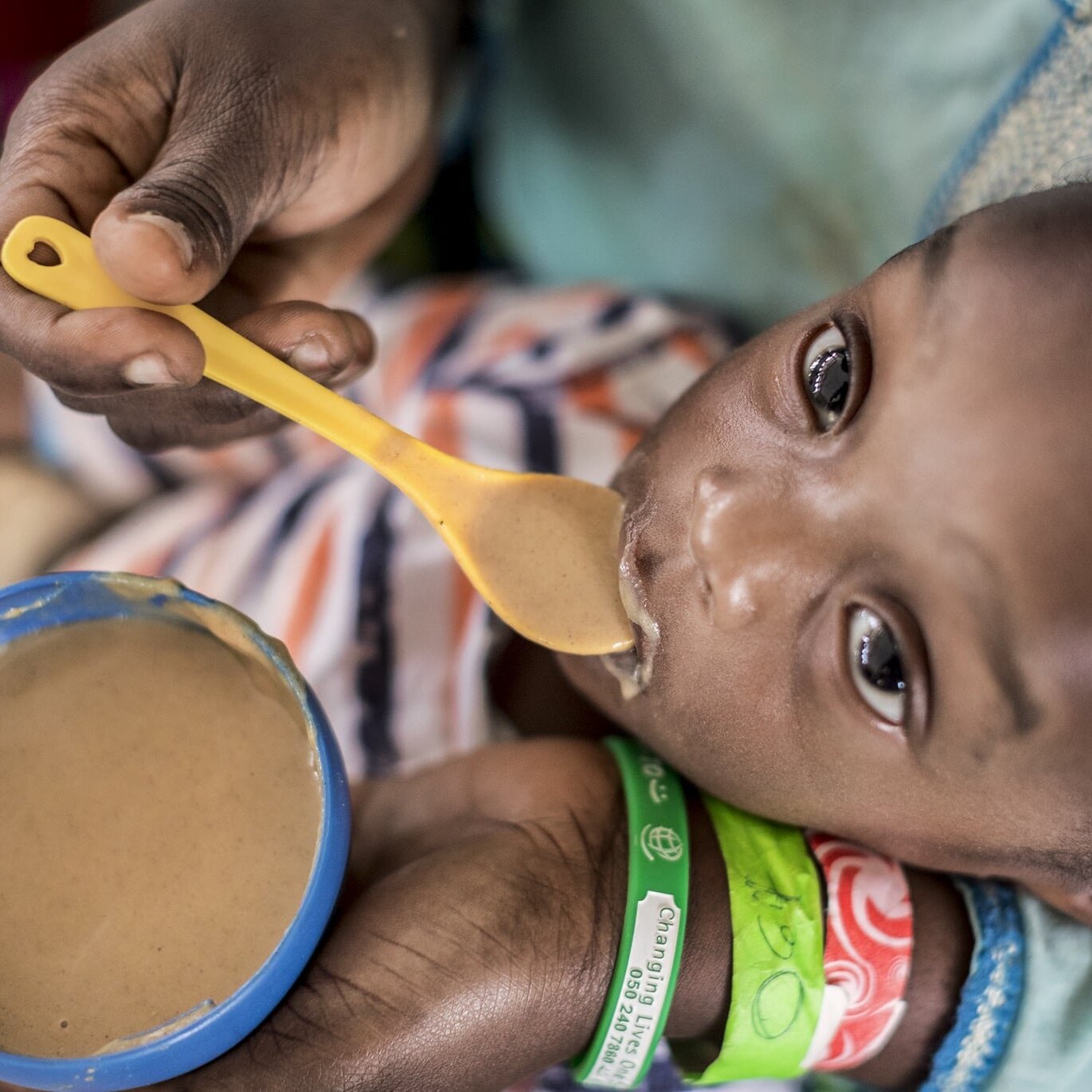 Nutritionist Dede Kwadjo feeds 1-year-old Nana.