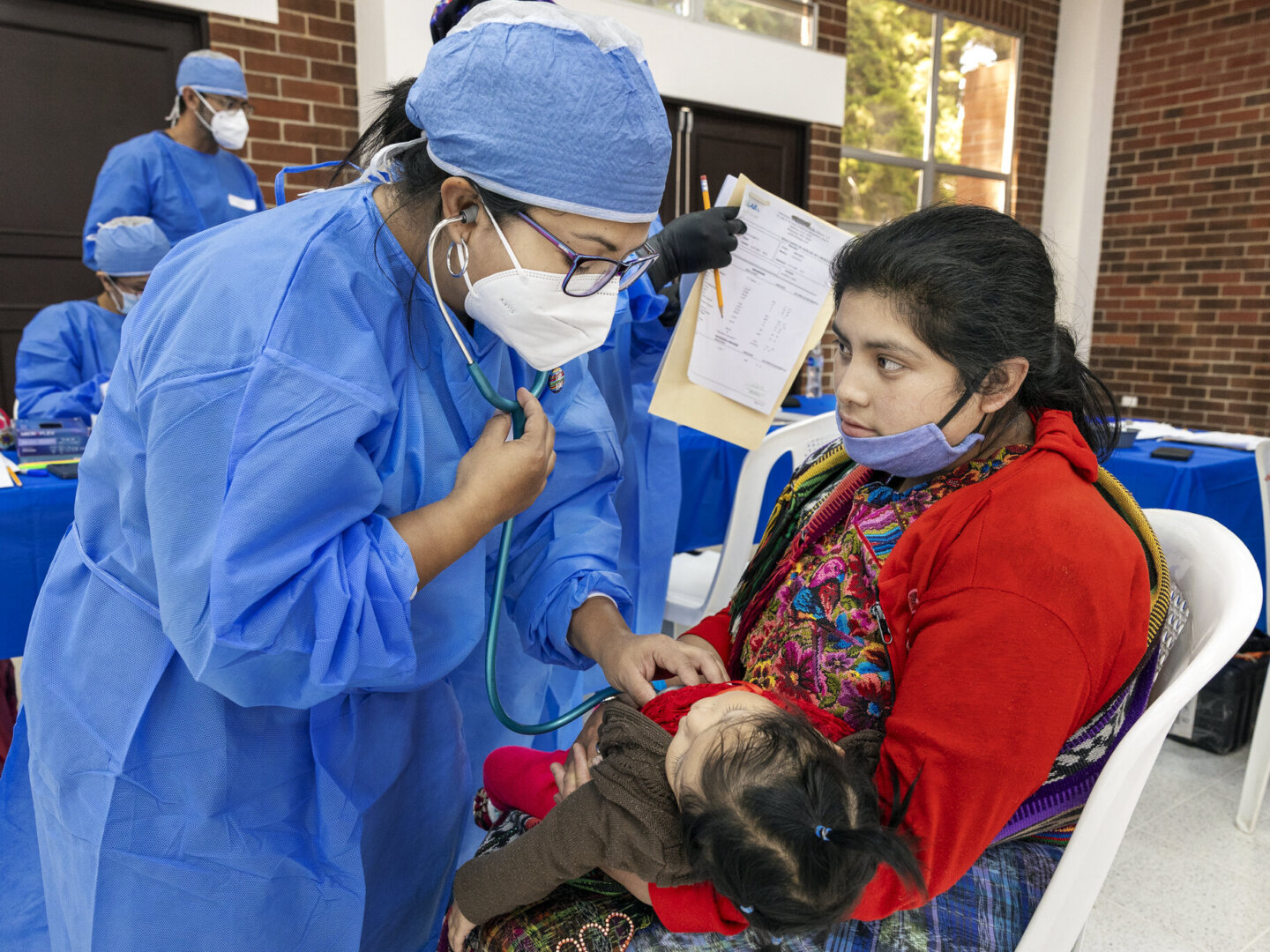 Leyda is examined by Operation Smile volunteers.