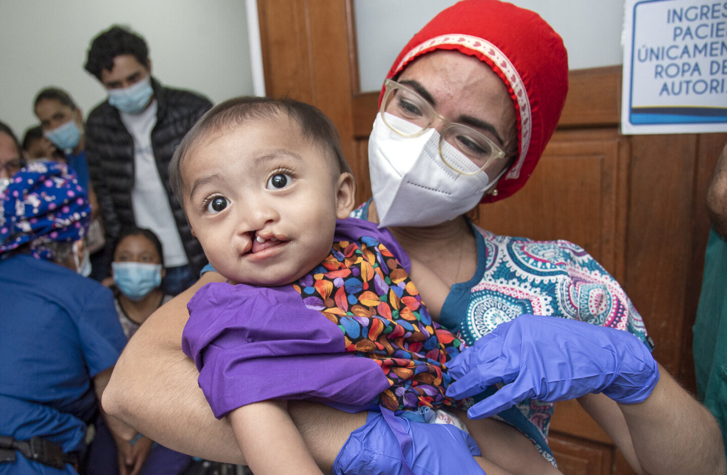Anesthesiologist Dr. Diana Gutierrez of Nicaragua carries 10-month-old Jobito into the operating room during Operation Smile’s 2022 surgical program in Guatemala City.