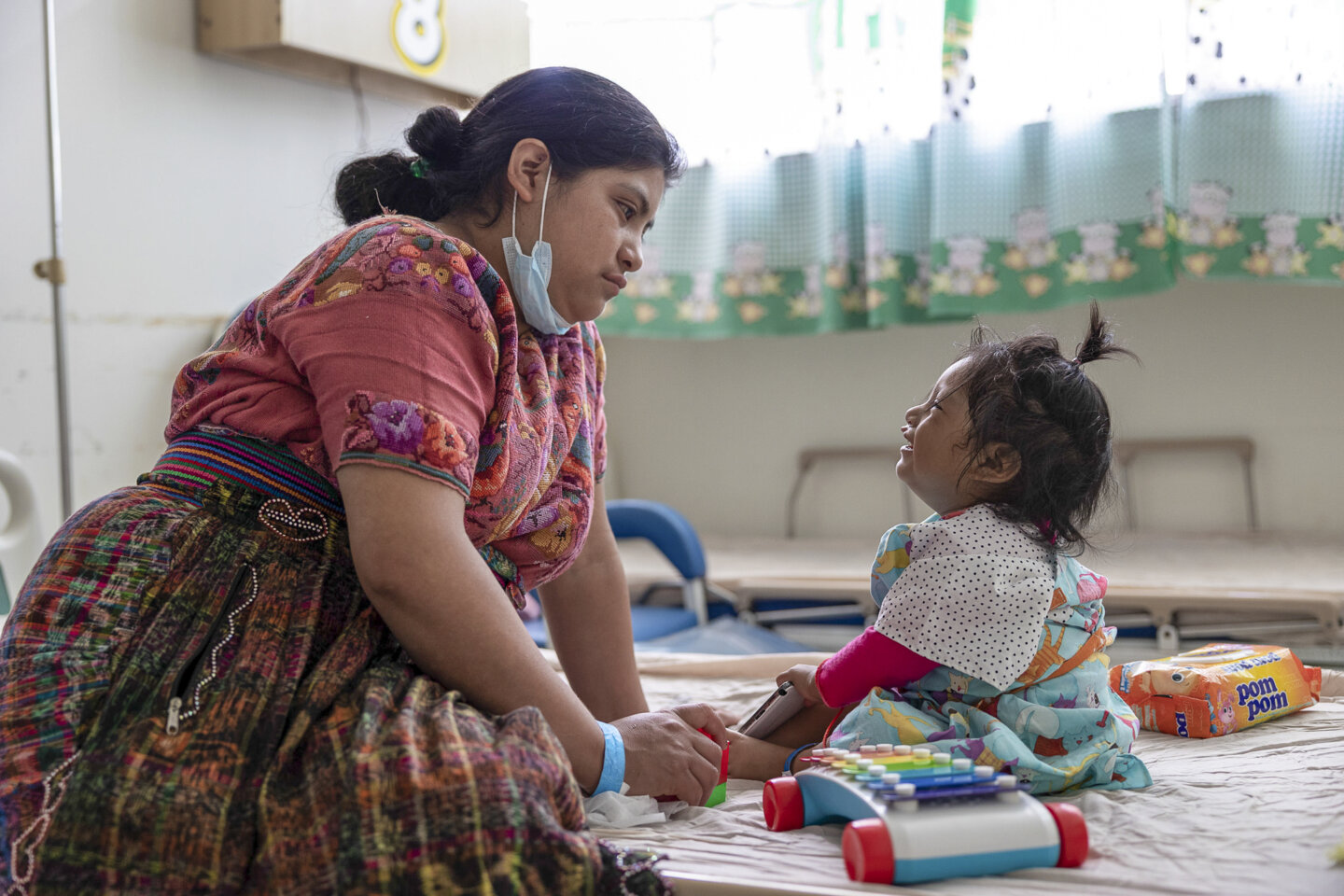 Heidy waits patiently with her 21-month-old daughter, Leyda, for the moment when volunteers will call her into the operating room.