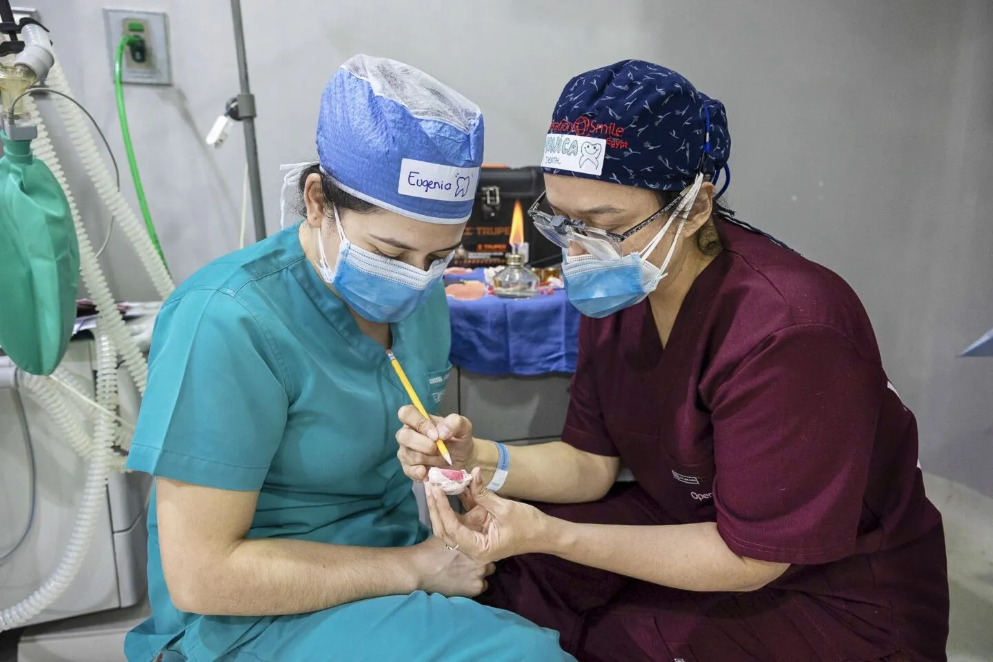 Volunteer dentist Dr. Monica De Leon of Guatemala, right, mentors fellow dentist Dr. Eugenia Azmitia of Guatemala about the specifics of creating obturators, which help patients born with cleft palate to feed.