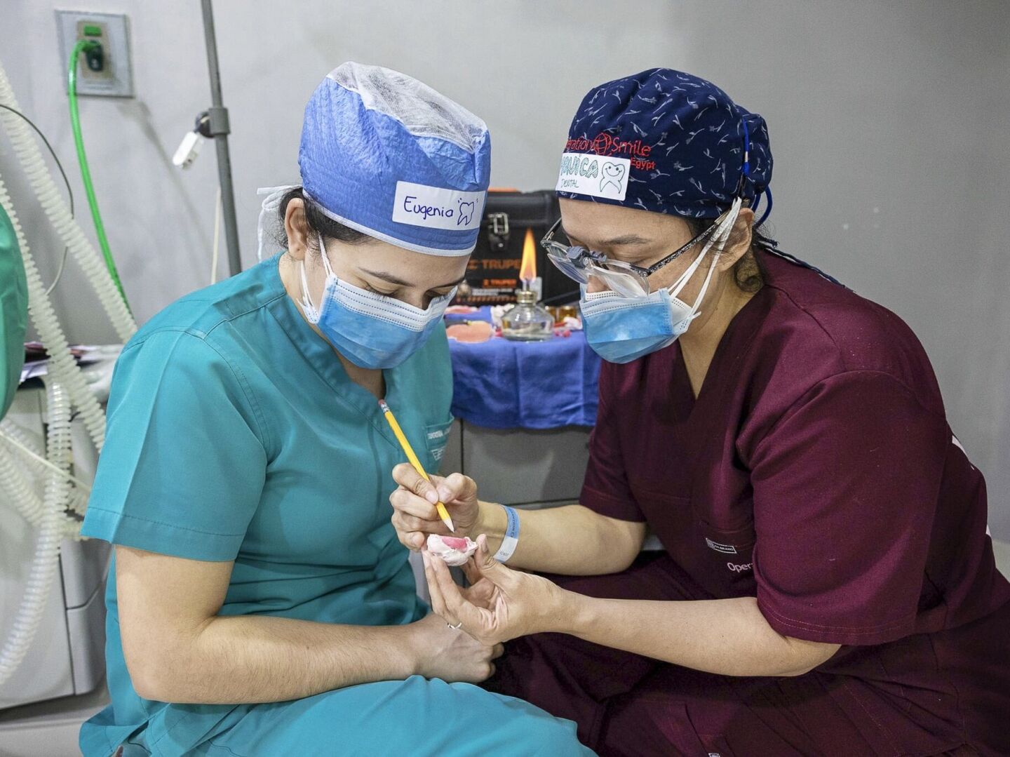 Volunteer dentist Dr. Monica De Leon of Guatemala, right, mentors fellow dentist Dr. Eugenia Azmitia of Guatemala about the specifics of creating obturators, which help patients born with cleft palate to feed.