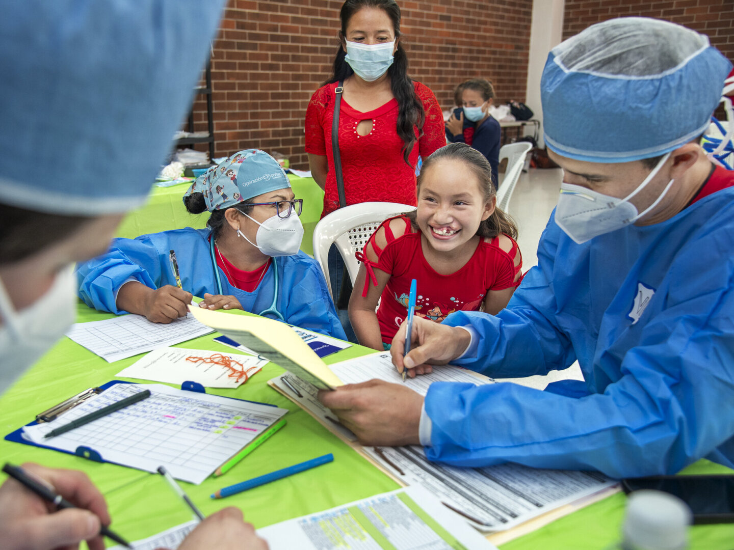 Dayana speaks with Operation Smile volunteers during a surgical program in Guatemala City, Guatemala.