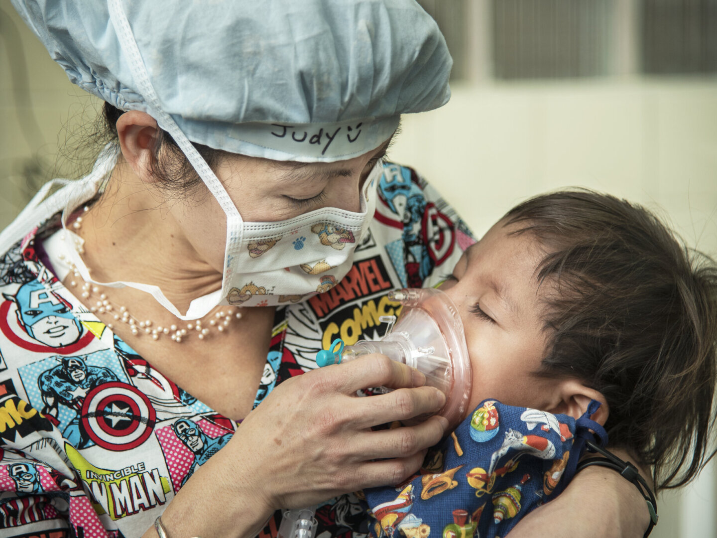 Dr. Judy Nguyen holds Juan Carlos during a surgical program in Honduras.